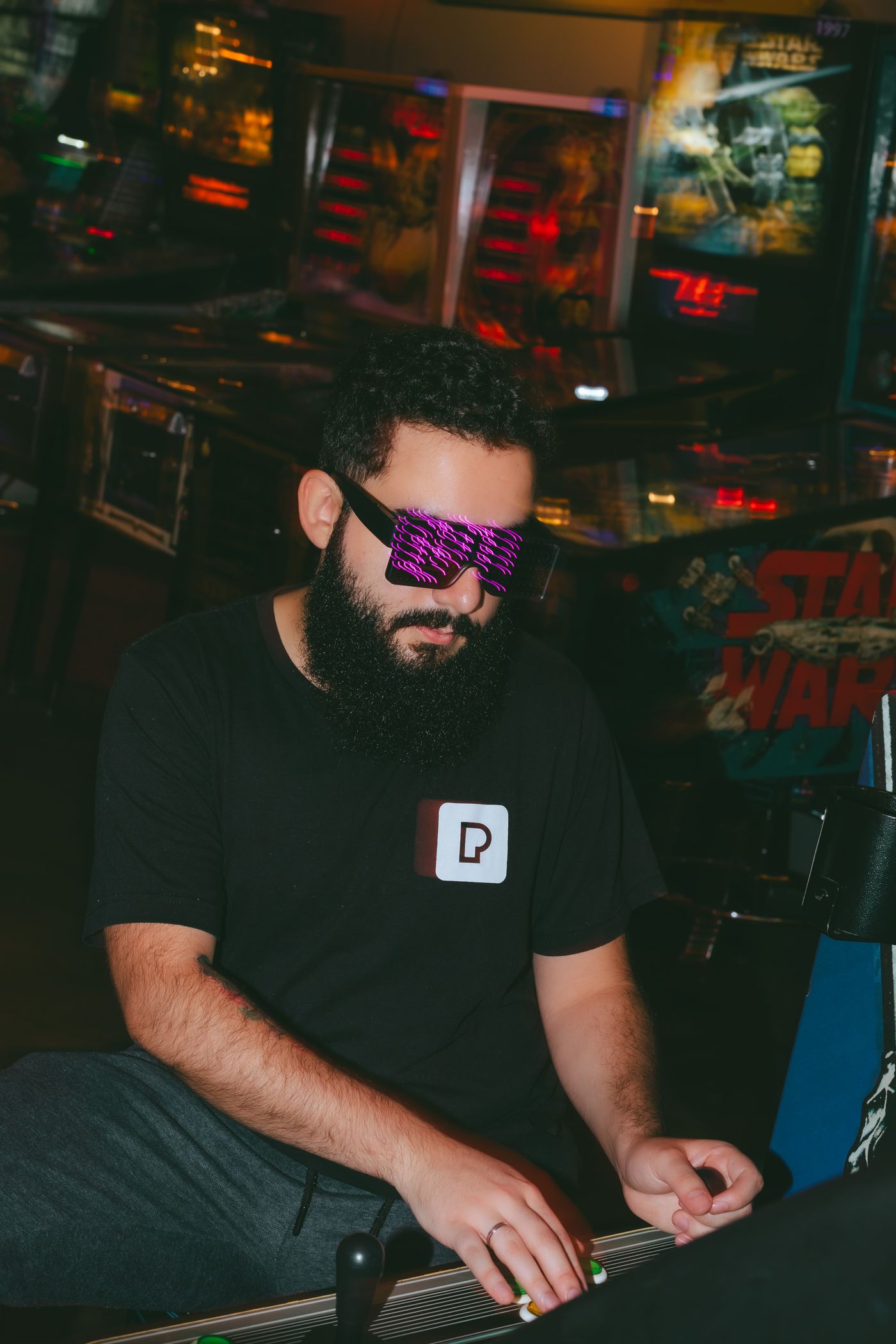 Player at a neon arcade machine