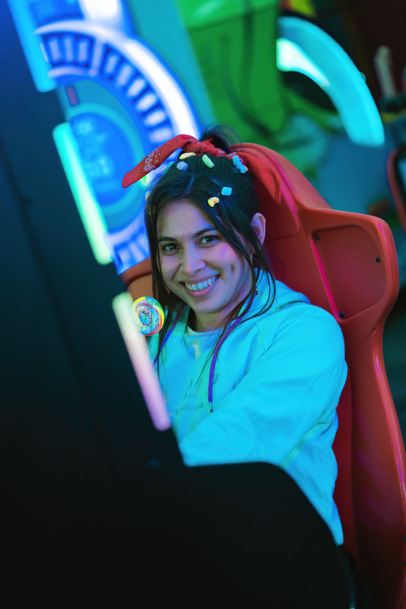 Woman playing a neon arcade game